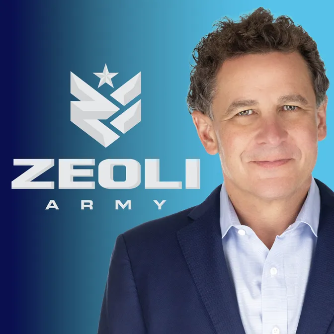 Man in a blue suit standing in front of a blue gradient background with the text “ZEOLI ARMY” and a star logo displayed to his left.